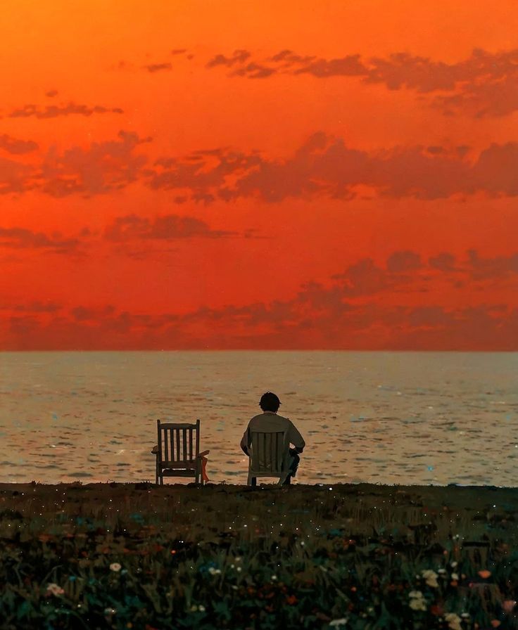 homme de dos sur une chaise au bord de la mer